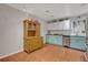Kitchen boasts light teal cabinets, granite counters, and stainless steel appliances at 2460 Oak Mill Dr, Kissimmee, FL 34744
