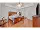 Main bedroom with king-size bed and wood dresser at 2460 Oak Mill Dr, Kissimmee, FL 34744