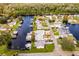 Aerial view of waterfront property with canal access and lush landscaping at 26603 W Cove Dr, Tavares, FL 32778