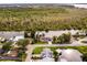 Aerial view showcasing a house on a canal with surrounding greenery at 26603 W Cove Dr, Tavares, FL 32778