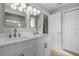 Modern bathroom with dual sinks, quartz countertop, and gold fixtures at 26603 W Cove Dr, Tavares, FL 32778