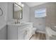 Updated bathroom with white vanity, quartz countertop, and a bathtub at 26603 W Cove Dr, Tavares, FL 32778