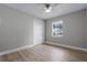Simple bedroom with neutral walls, wood-look floors, and a window at 26603 W Cove Dr, Tavares, FL 32778