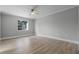 Bright bedroom with light gray walls, wood-look flooring, and a window at 26603 W Cove Dr, Tavares, FL 32778