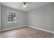 Light and airy bedroom featuring a window with a view and ceiling fan at 26603 W Cove Dr, Tavares, FL 32778