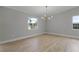 Dining room with new chandelier and hardwood floors at 26603 W Cove Dr, Tavares, FL 32778