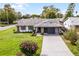 Charming ranch-style home with stone accents, updated exterior and a spacious lawn at 26603 W Cove Dr, Tavares, FL 32778