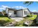 Side view of home with patio and fenced backyard at 26603 W Cove Dr, Tavares, FL 32778