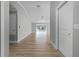 Bright hallway with light gray walls and wood flooring at 26603 W Cove Dr, Tavares, FL 32778