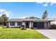 Newly renovated home with gray exterior and a well-manicured lawn at 26603 W Cove Dr, Tavares, FL 32778