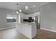 Modern white kitchen with island and stainless steel appliances at 26603 W Cove Dr, Tavares, FL 32778