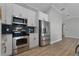 Stainless steel appliances and dark-tile backsplash in this updated kitchen at 26603 W Cove Dr, Tavares, FL 32778