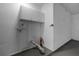 Simple laundry area with cabinets and space for washer and dryer at 26603 W Cove Dr, Tavares, FL 32778