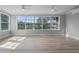 Bright living room showcasing large windows and water views at 26603 W Cove Dr, Tavares, FL 32778