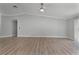 Spacious living room with light gray walls and wood-look flooring at 26603 W Cove Dr, Tavares, FL 32778