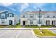 Two-story townhome with gray and blue siding, a paved walkway, and a well-maintained lawn at 281 Jetty Way, Davenport, FL 33897