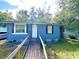 Cute blue house with a ramp and a spacious yard at 30 E Ella J Gilmore St, Apopka, FL 32703