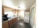 Small kitchen with wood cabinets and laminate floor at 30 E Ella J Gilmore St, Apopka, FL 32703