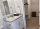 Modern bathroom with a vanity, sink, and walk-in closet at 310 Gardenia Ct, Poinciana, FL 34759