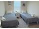 Two twin beds in a well-lit bedroom, perfect for guests at 310 Gardenia Ct, Poinciana, FL 34759