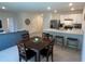 Open concept dining area with square table and kitchen view at 310 Gardenia Ct, Poinciana, FL 34759