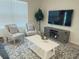 Cozy living room with comfortable seating and large TV at 310 Gardenia Ct, Poinciana, FL 34759