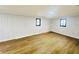Bright bedroom featuring wood-look flooring and updated wall paneling at 4171 Radford Rd, Bartow, FL 33830