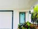 Modern teal front door and white garage door at 4171 Radford Rd, Bartow, FL 33830