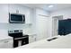 Modern kitchen with white cabinets, stainless steel appliances, and quartz countertops at 4171 Radford Rd, Bartow, FL 33830