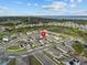 Aerial view of a home in a residential neighborhood near a lake at 489 Avila Pl, Howey In The Hills, FL 34737