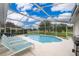 Relaxing pool area with lounge chairs and screened enclosure at 577 Sunridge Woods Blvd, Davenport, FL 33837