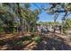 Tan house exterior with wood-lined accents nestled among trees at 701 Greentree Ct, Lake Mary, FL 32746