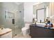 Modern bathroom with glass shower and dark vanity at 15144 Pendio Dr, Montverde, FL 34756
