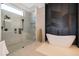 Luxurious bathroom with a large walk-in shower and a free-standing soaking tub at 15144 Pendio Dr, Montverde, FL 34756