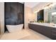 Spa-like bathroom featuring a soaking tub, double sinks, and a walk-in shower at 15144 Pendio Dr, Montverde, FL 34756