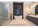 Elegant bathroom with freestanding tub, walk-in shower, and modern double vanity at 15144 Pendio Dr, Montverde, FL 34756