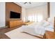Main bedroom with king-size bed and wood floors at 15144 Pendio Dr, Montverde, FL 34756