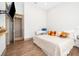 Spacious bedroom with large bed, wood floors, and mounted TV at 15144 Pendio Dr, Montverde, FL 34756