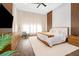Main bedroom with king-size bed and wood floors at 15144 Pendio Dr, Montverde, FL 34756