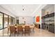 Elegant dining room features a large wooden table and modern lighting at 15144 Pendio Dr, Montverde, FL 34756