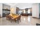 Open dining area with a live edge table and modern light fixture at 15144 Pendio Dr, Montverde, FL 34756