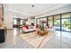 Open concept living room with a view of the pool and kitchen at 15144 Pendio Dr, Montverde, FL 34756