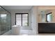 Bathroom with freestanding tub and large window at 15614 Espalier Way, Winter Garden, FL 34787