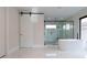 Elegant bathroom with freestanding tub and frameless shower at 15614 Espalier Way, Winter Garden, FL 34787