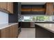 Modern kitchen with sleek cabinetry, stainless steel appliances, and expansive windows at 15614 Espalier Way, Winter Garden, FL 34787