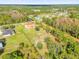 Aerial view of a two-story house with a large yard and surrounding trees at 19206 Robertson St, Orlando, FL 32833