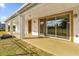 Covered patio with sliding glass doors leading into the home and a fire pit at 19206 Robertson St, Orlando, FL 32833