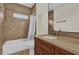 Clean bathroom with tiled walls, bathtub, and modern vanity with granite countertop at 19206 Robertson St, Orlando, FL 32833