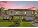 Two-story house with a red tile roof, stone accents, and a three-car garage at 19206 Robertson St, Orlando, FL 32833