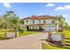 Large two-story house with a brick driveway and landscaped front yard at 19206 Robertson St, Orlando, FL 32833